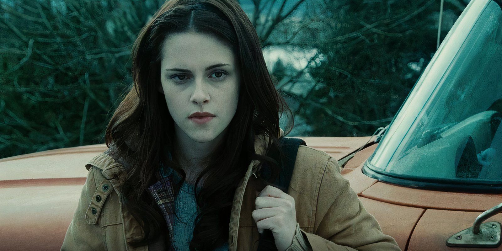 Kristen Stewart as Bella Swan standing by her truck.