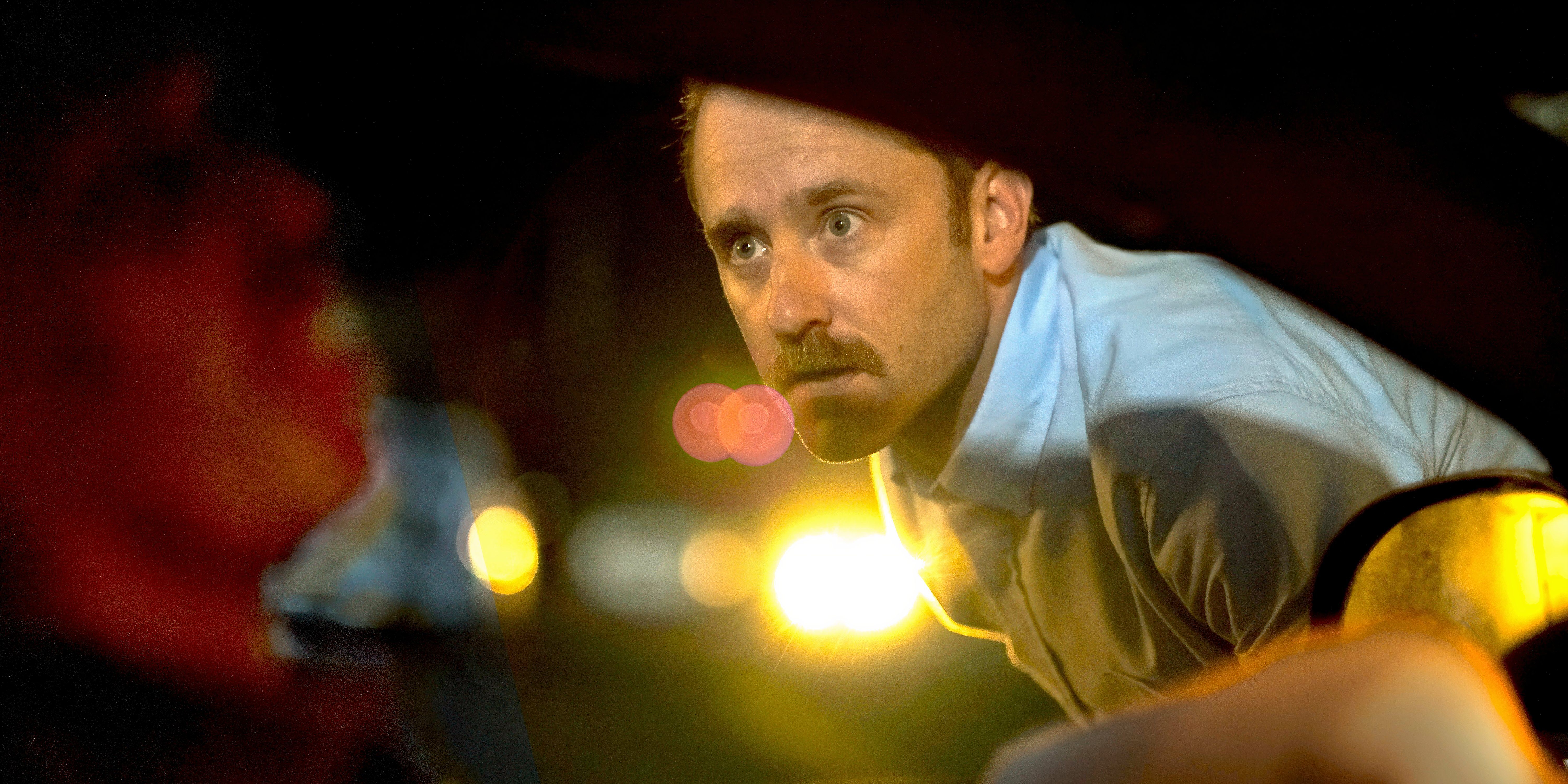 Ben Foster leans into a car window in Sharp Corner