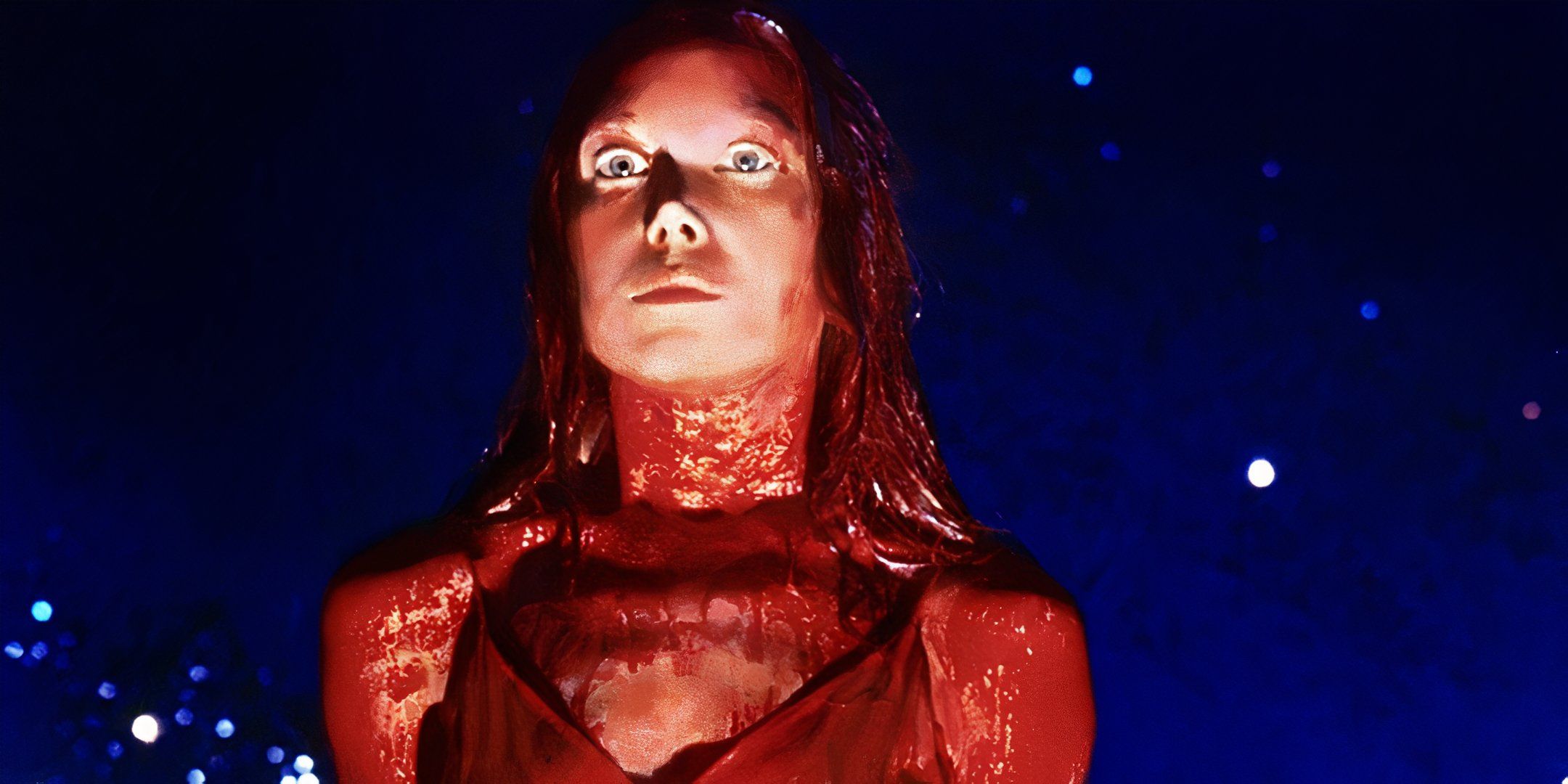 Carrie looks on with large eyes while covered in blood from Carrie (1976)