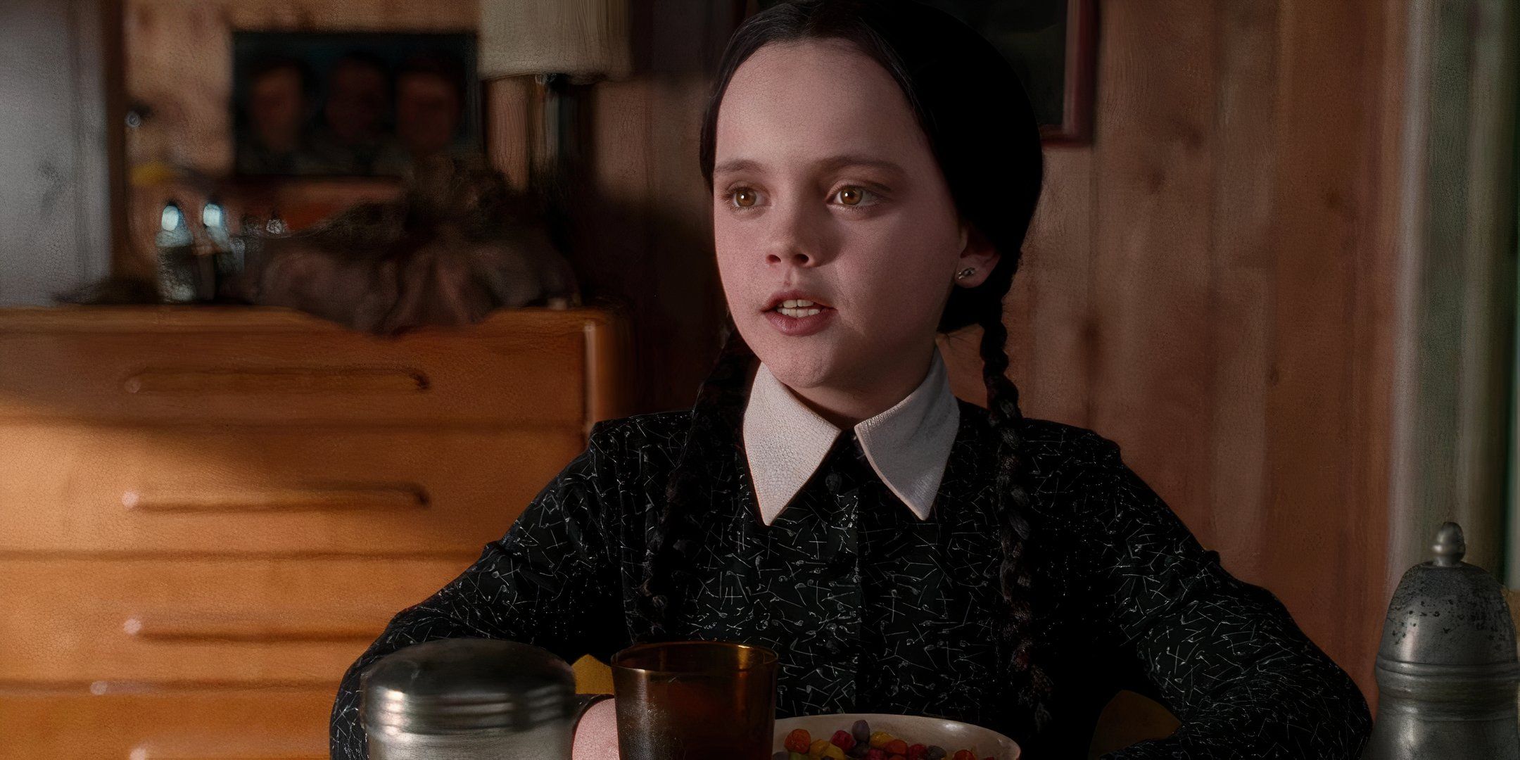 Christina Ricci sits down at a table during a conversation. 