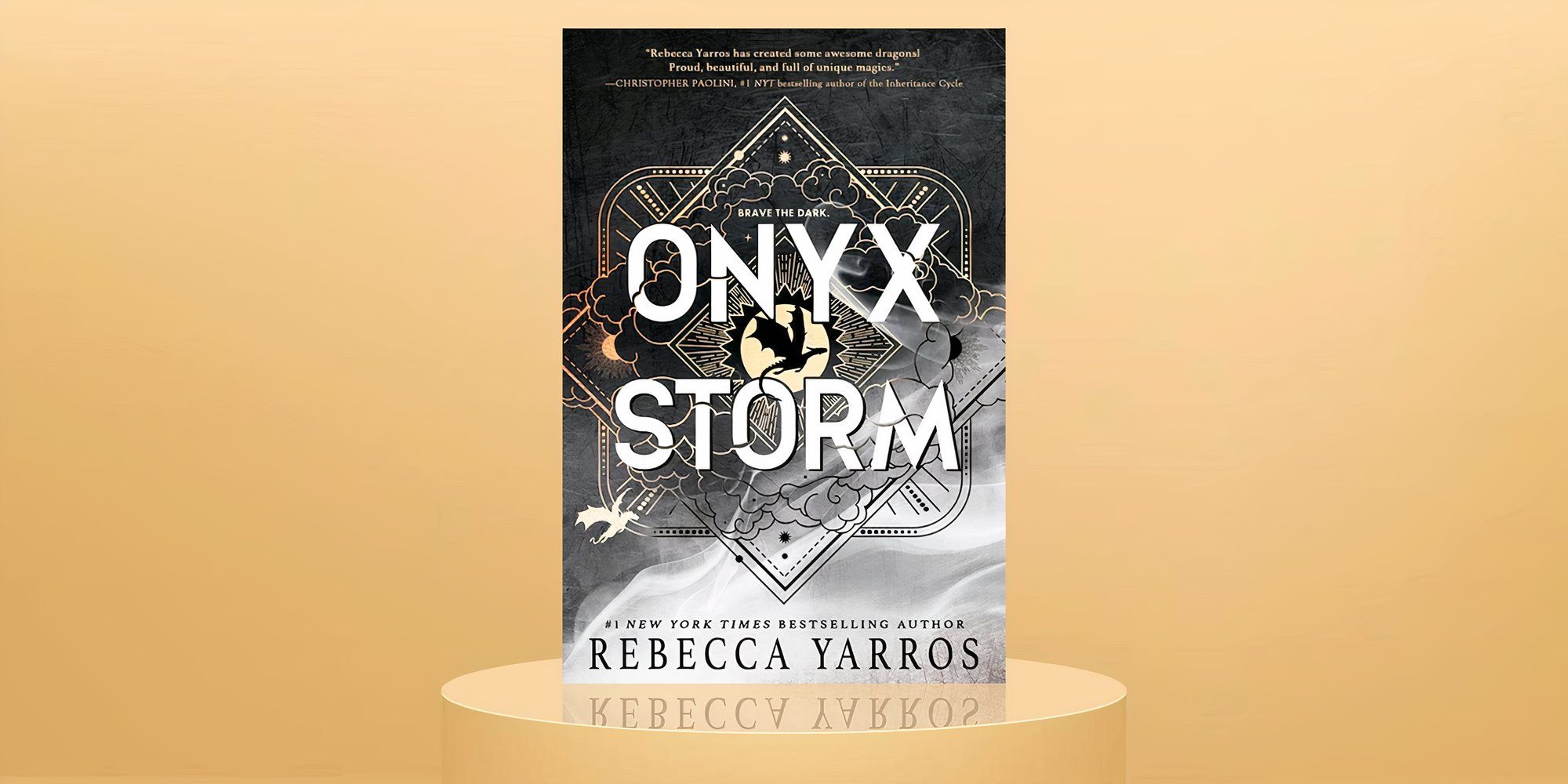 The cover of Onyx Storm on a pedestal with a beige background.