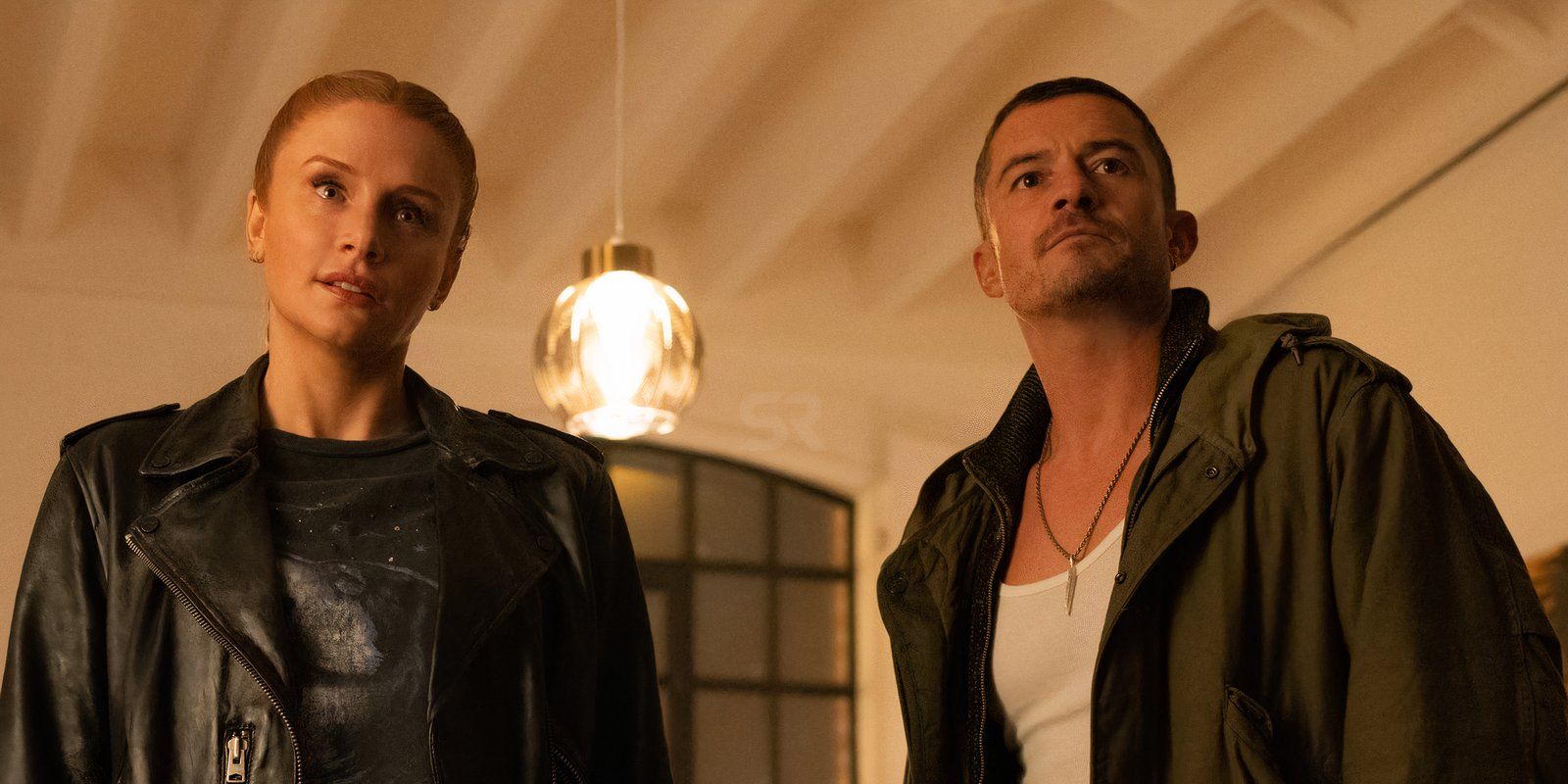 Bryce Dallas Howard as Kat stands next to Orlando Bloom as Marlon in Deep Cover
