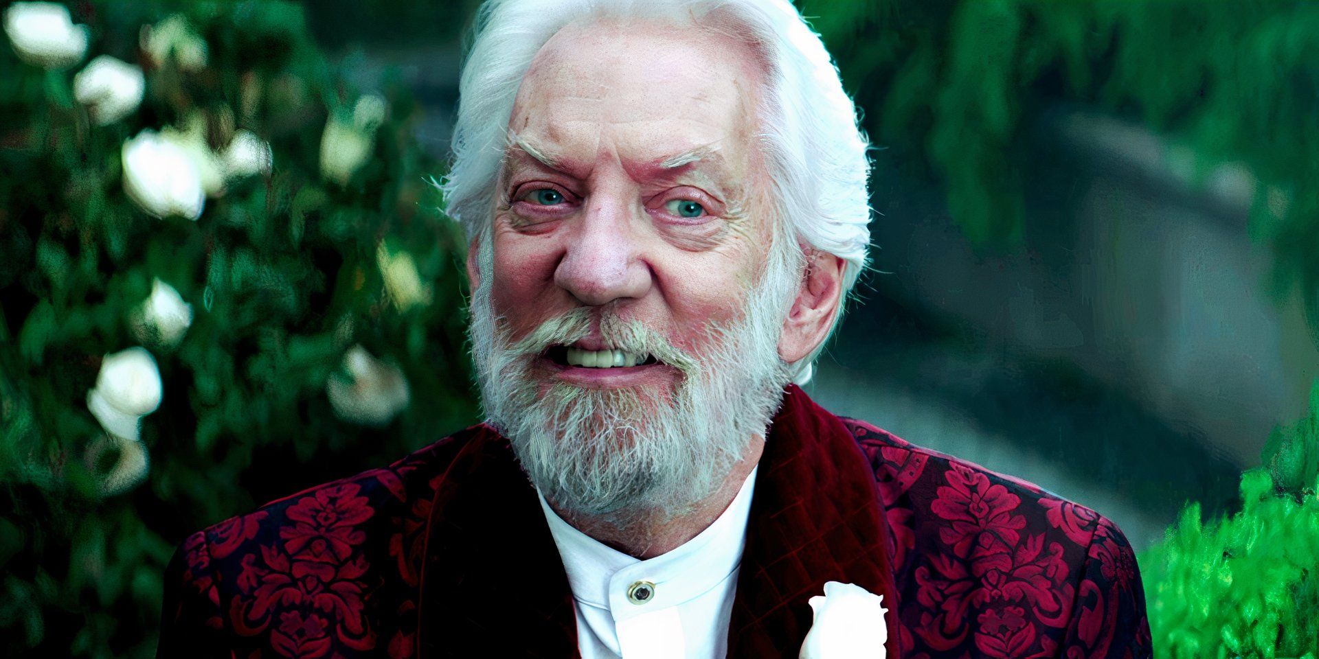 Donald Sutherland as President Snow smiling in The Hunger Games Mockingjay Part 2