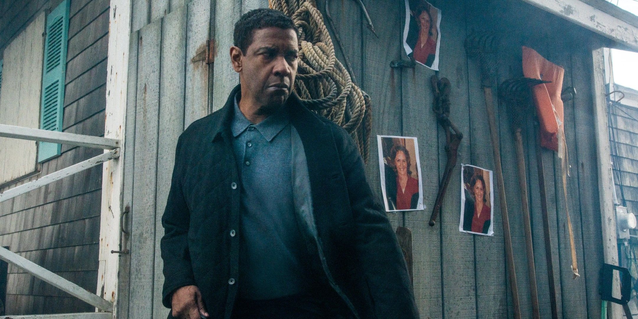 Robert McCall peeks around a corner looking suspicious in The Equalizer 2