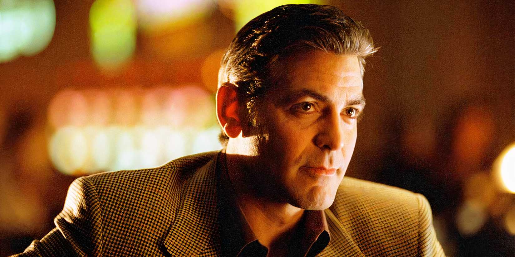 George Clooney as Danny Ocean watching someone in Ocean's Eleven