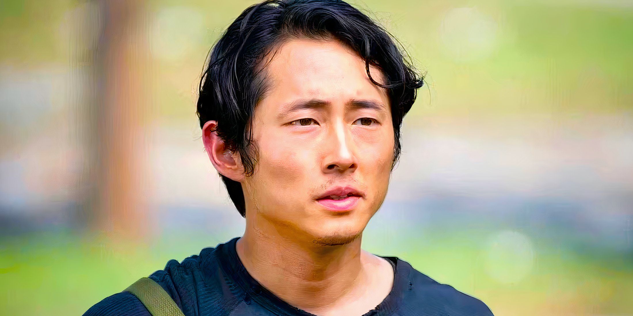 Glenn standing along with a backpack in The Walking Dead