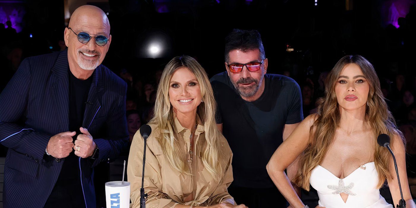 Heidi Klum from America's Got Talent smiling with Howie Mandel, Simon Cowell, and Sophia Vergara.