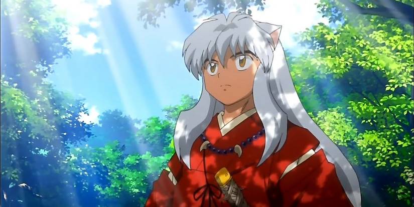 Inuyasha standing in a forest as light streaks through the trees.