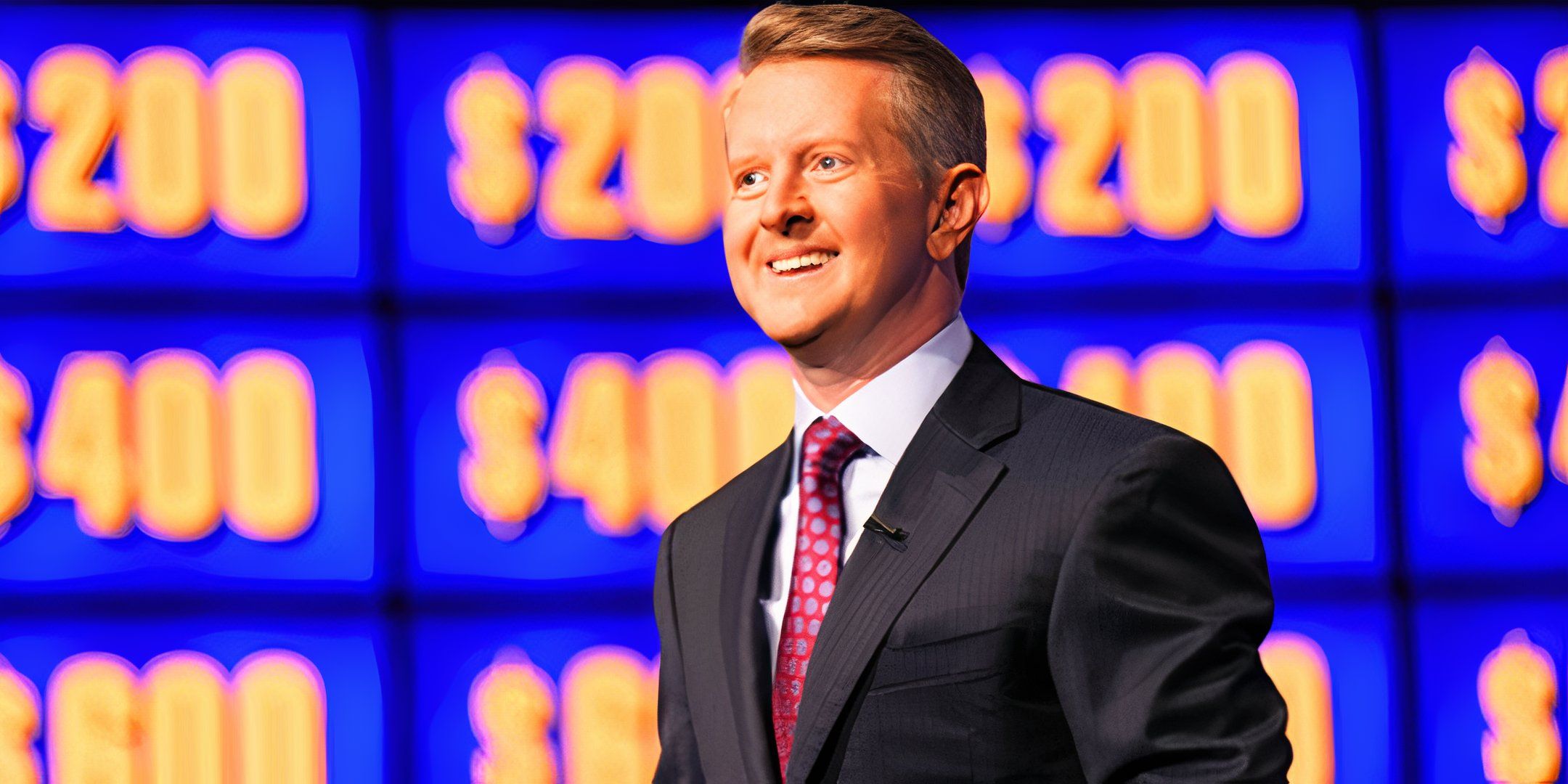 Jeopardy! Host Ken Jennings Smiling In Front Of The Jeopardy! Board