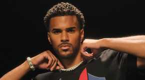 Jeremiah Brown from Love Island USA posing in front of a black backdrop.