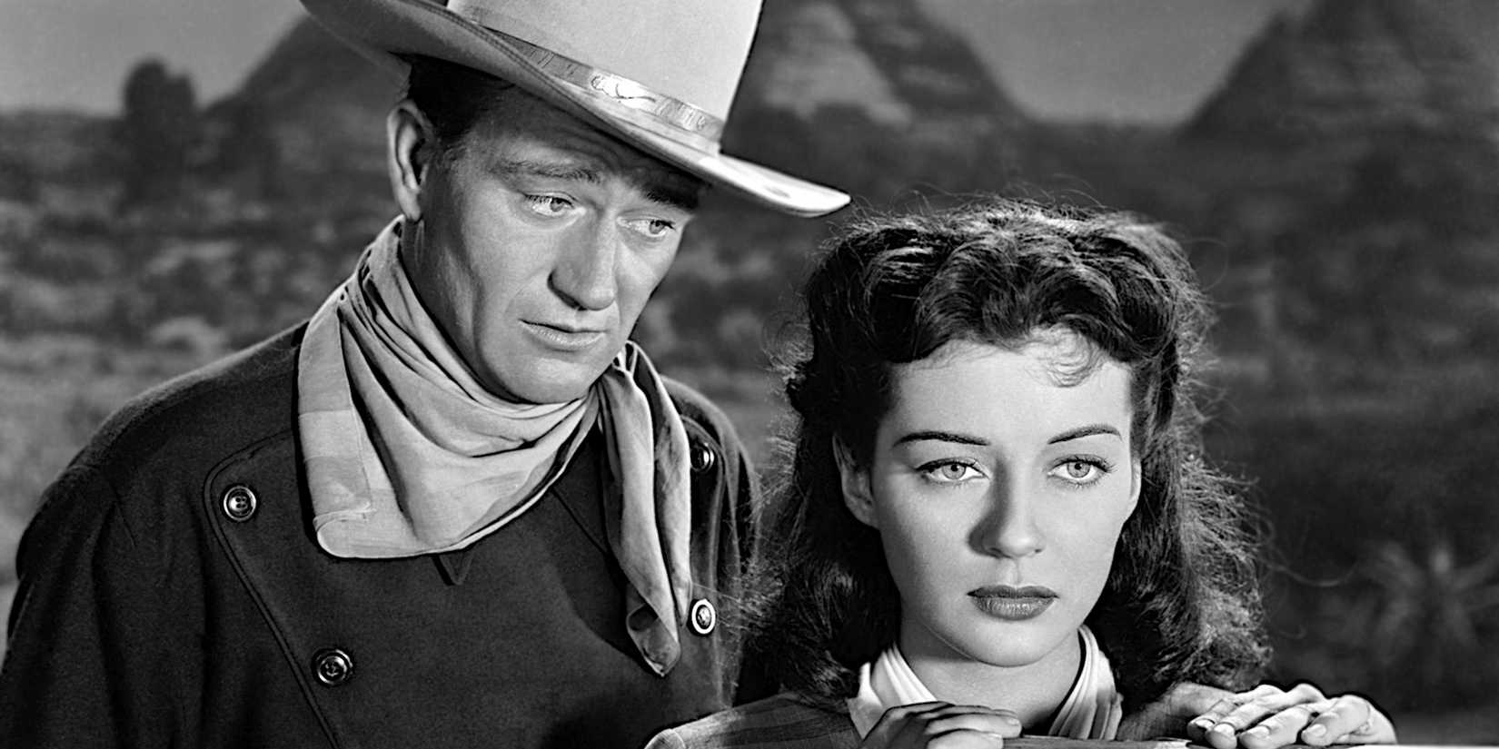 John Wayne talks to Gail Russell who gazes seriously into the distance in a scene from Angel and the Badman