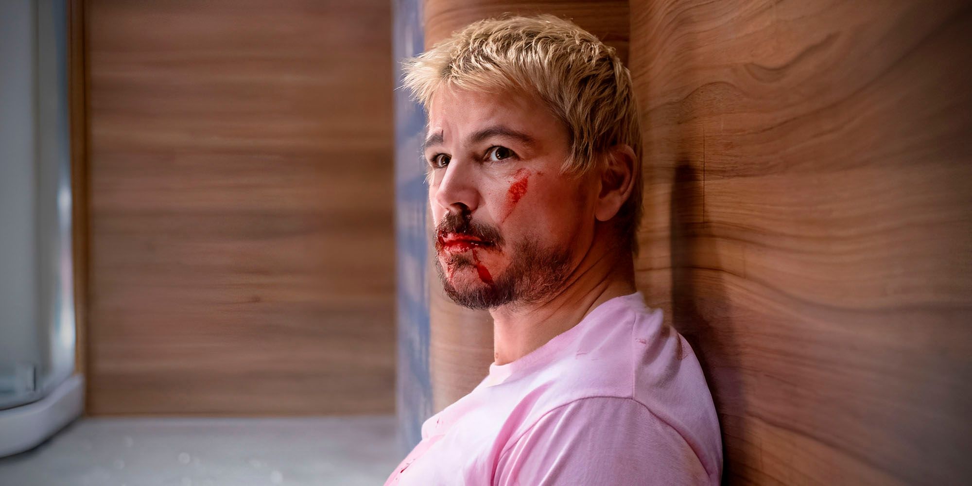 Josh Hartnett as a bloodied Lucas Reyes sitting against a wall in Fight or Flight