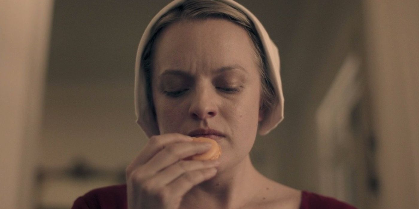 June eating a macaron in The Handmaid's Tale season 1, episode 2