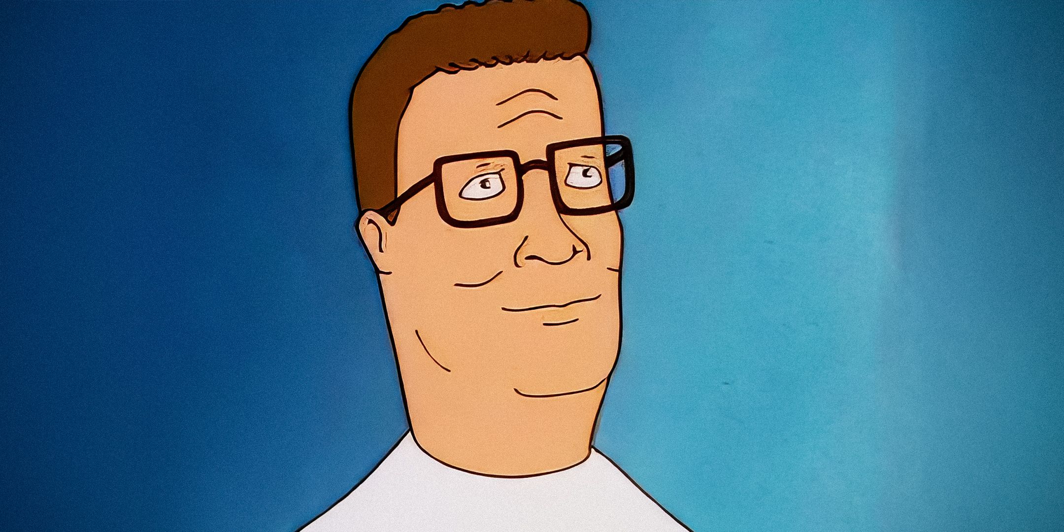 Hank Hill from King of the Hill smiling in front of a blue background.