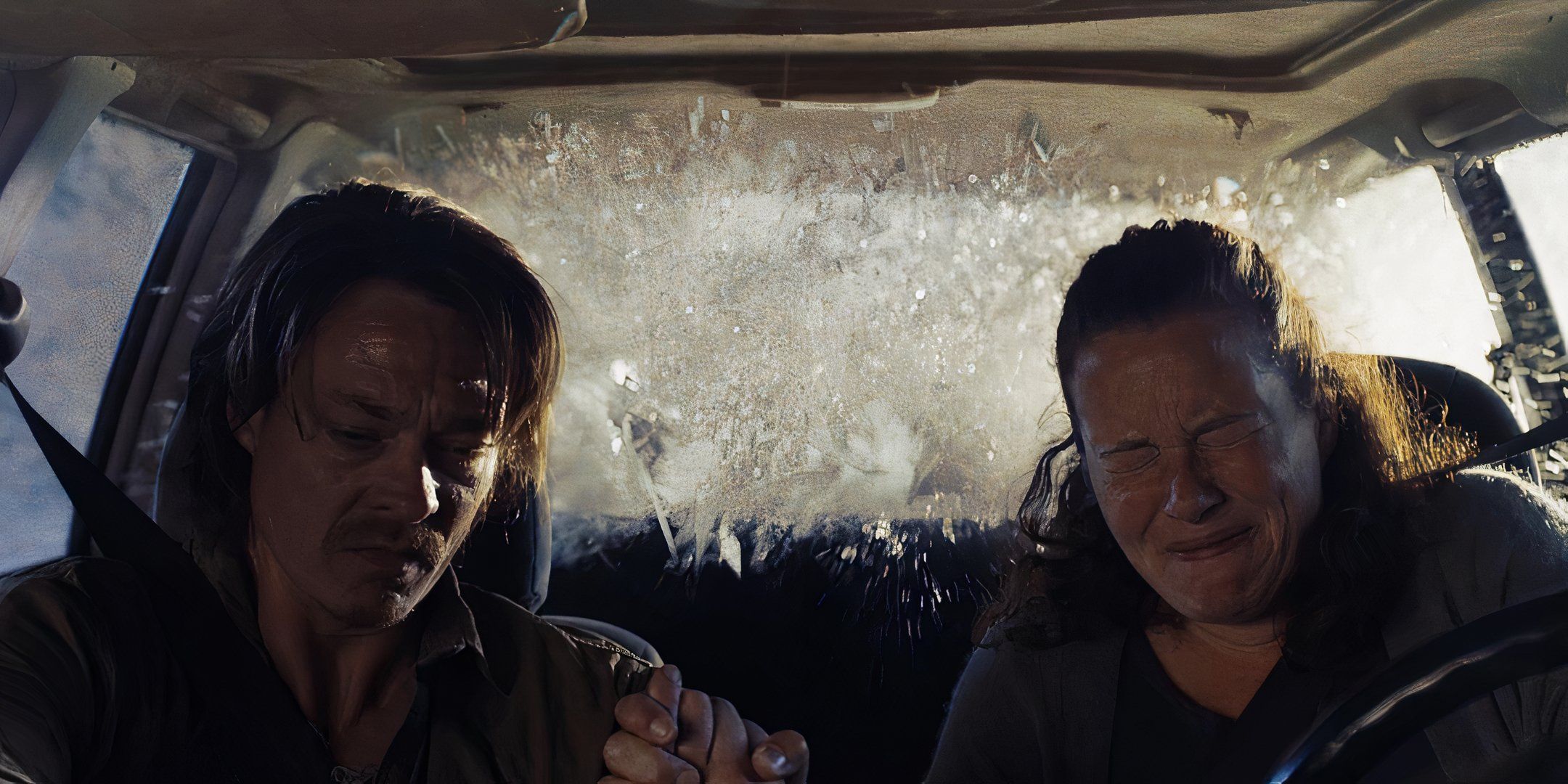 Kristoffer Joner and Silje Breivik sit in the front seats of a car, holding each other's hands тιԍнтly as water flows through the back of the car.
