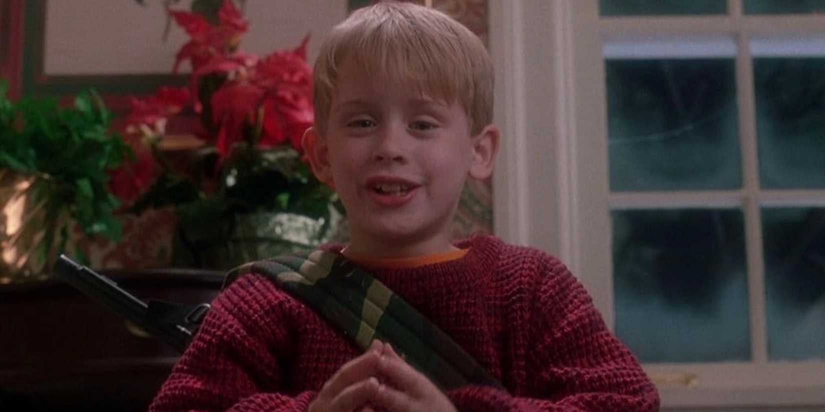 Macaulay Culkin presses his fingertips together and smiles mischievously in Home Alone 