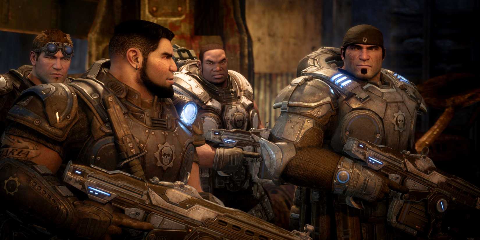 Marcus, Dom, Baird, and Cole standing next to each other with guns in Gears of War: Reloaded.