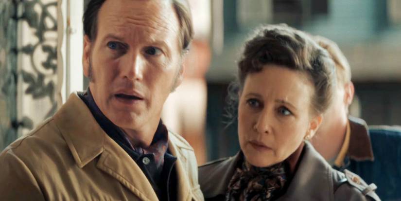 Patrick Wilson and Vera Farmiga as Ed and Lorraine Warren standing in a doorway in The Conjuring Last Rites
