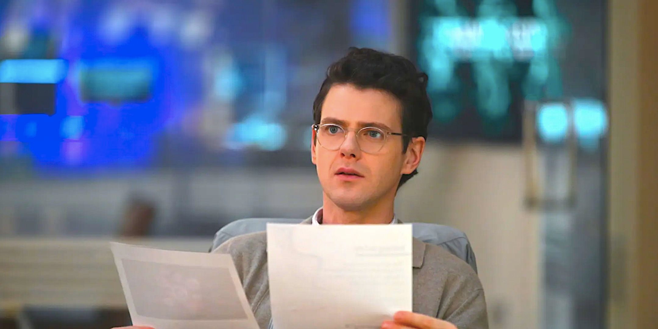 Peter Mark Kendall's Adam looks worried as he reads documents from Watson season 1