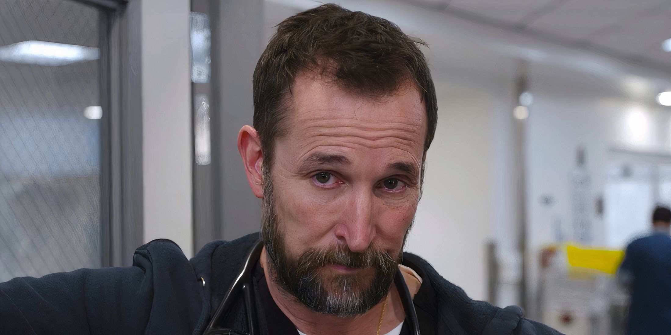 Robby looking extremely serious standing in a doorway in The Pitt season 1 episode 14
