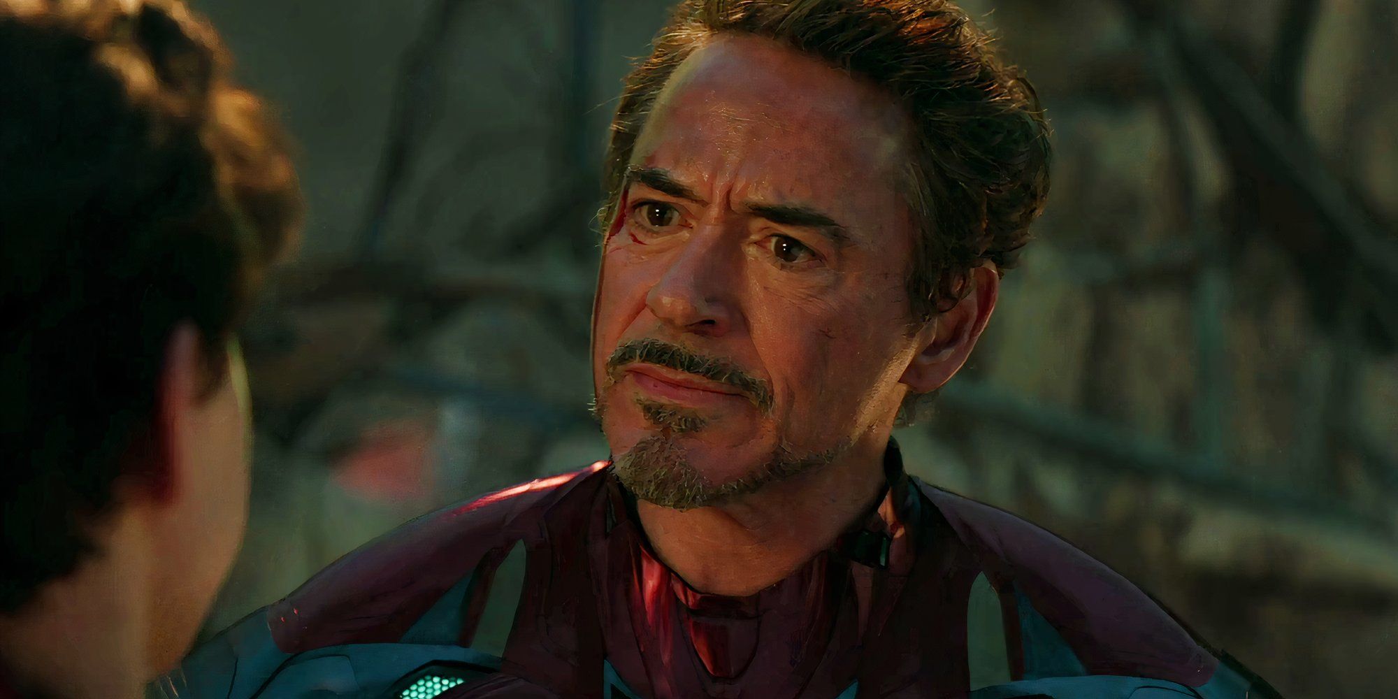 Robert Downey Jr.'s Iron Man looking emotionally at Spider-Man in Avengers: Endgame