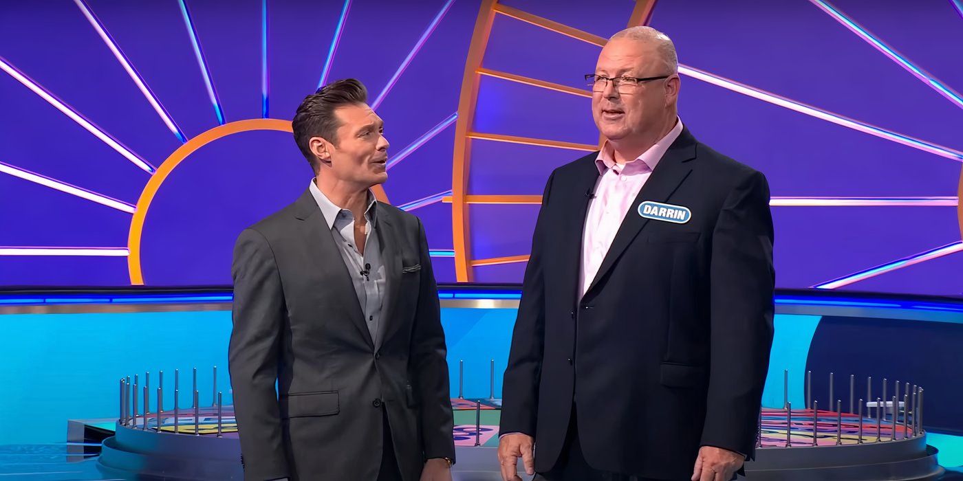 Wheel of Fortune host Ryan Seacrest and contestant Darrin “Poppa” Gallagher standing on stage together