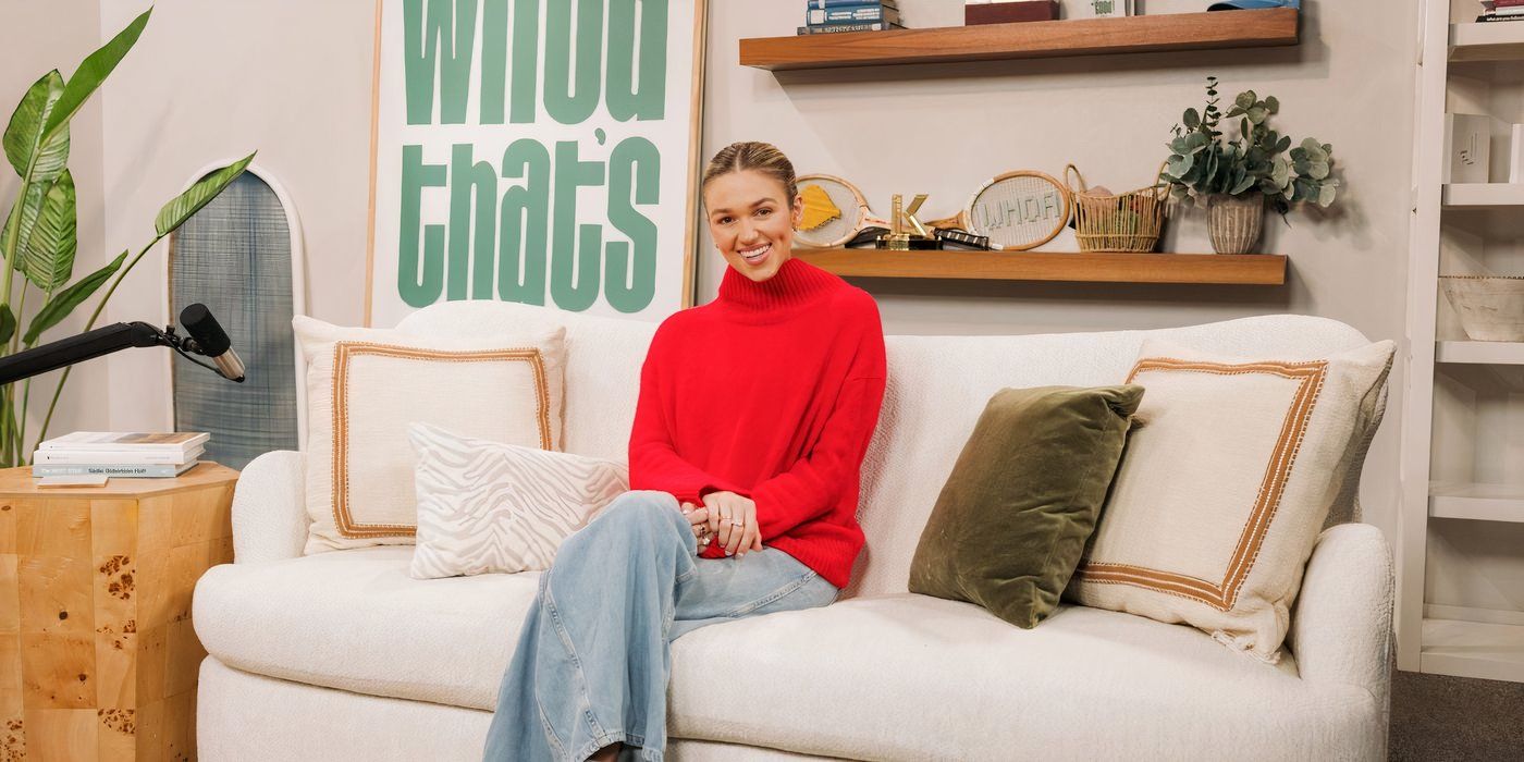 Duck Dynasty: The Revival's Sadie Robertson sitting on a couch wearing a red sweater