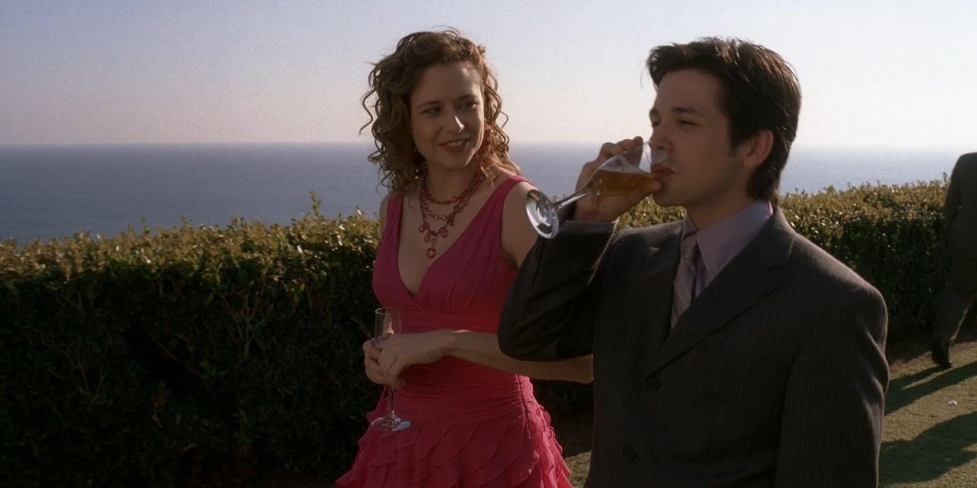 Sharon (Jenna Fischer) talking to Rico (Freddy Rodriguez) as he drinks wine in Six Feet Under.