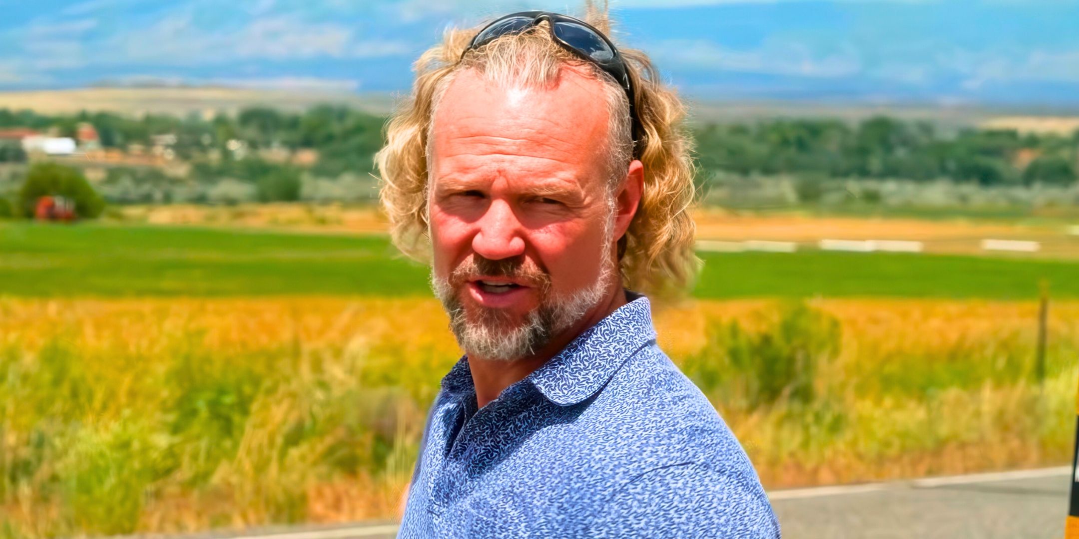 Sister Wives Kody Brown close up talking and looking to the side with landscape background