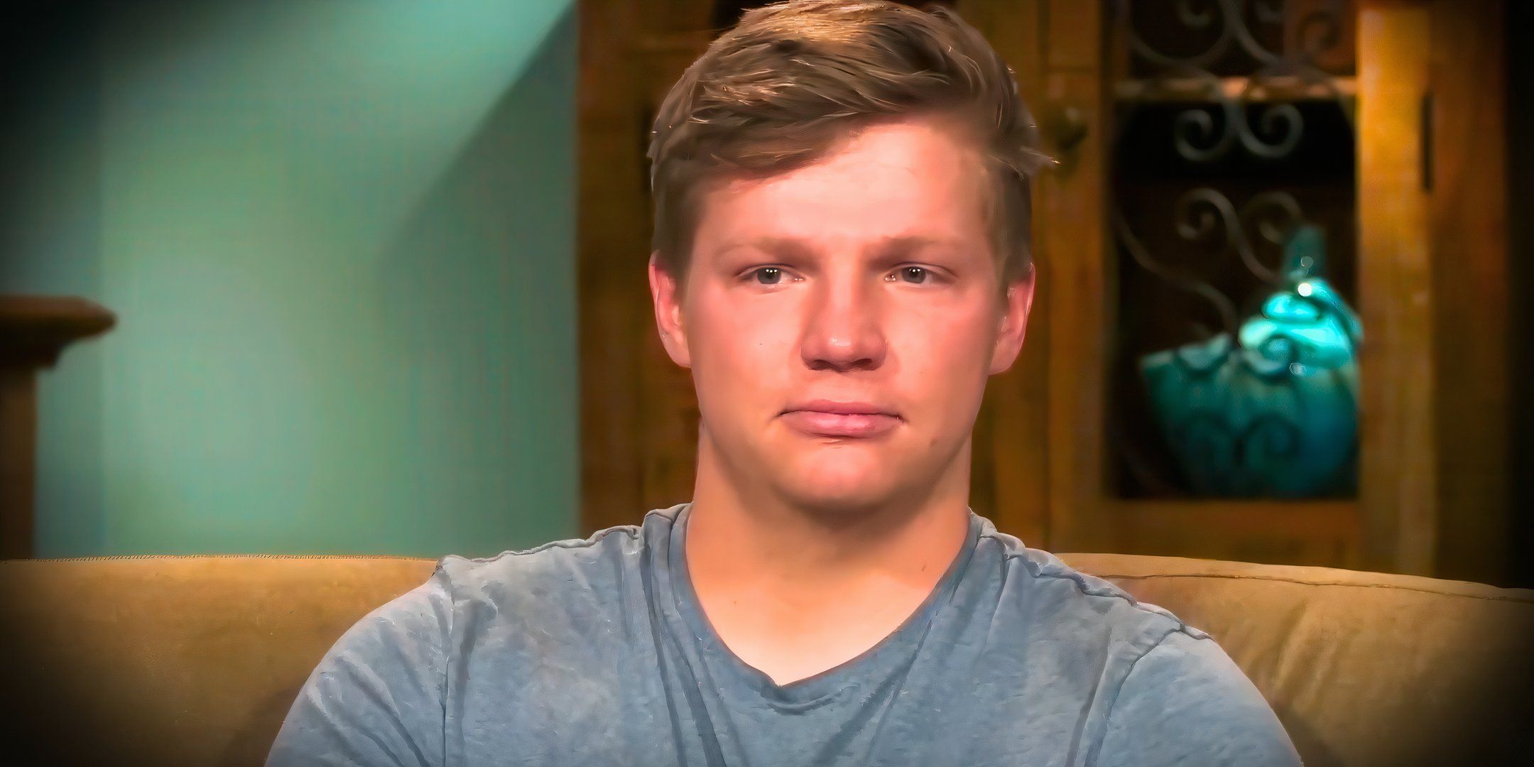Sister Wives Season 19 star Garrison Brown looking sad on the couch in still photo from show