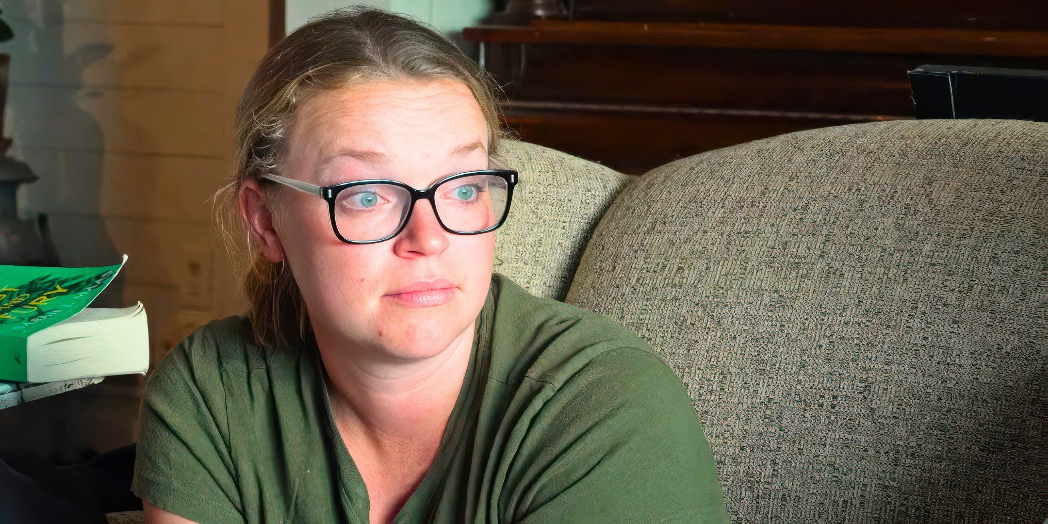 Sister Wives Madison Brush wearing glasses and looking off to the side