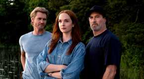 Chad Michael Murray, Morgan Kohan, and Scott Patterson standing by the water in a promotional image for Sullivan's Crossing
