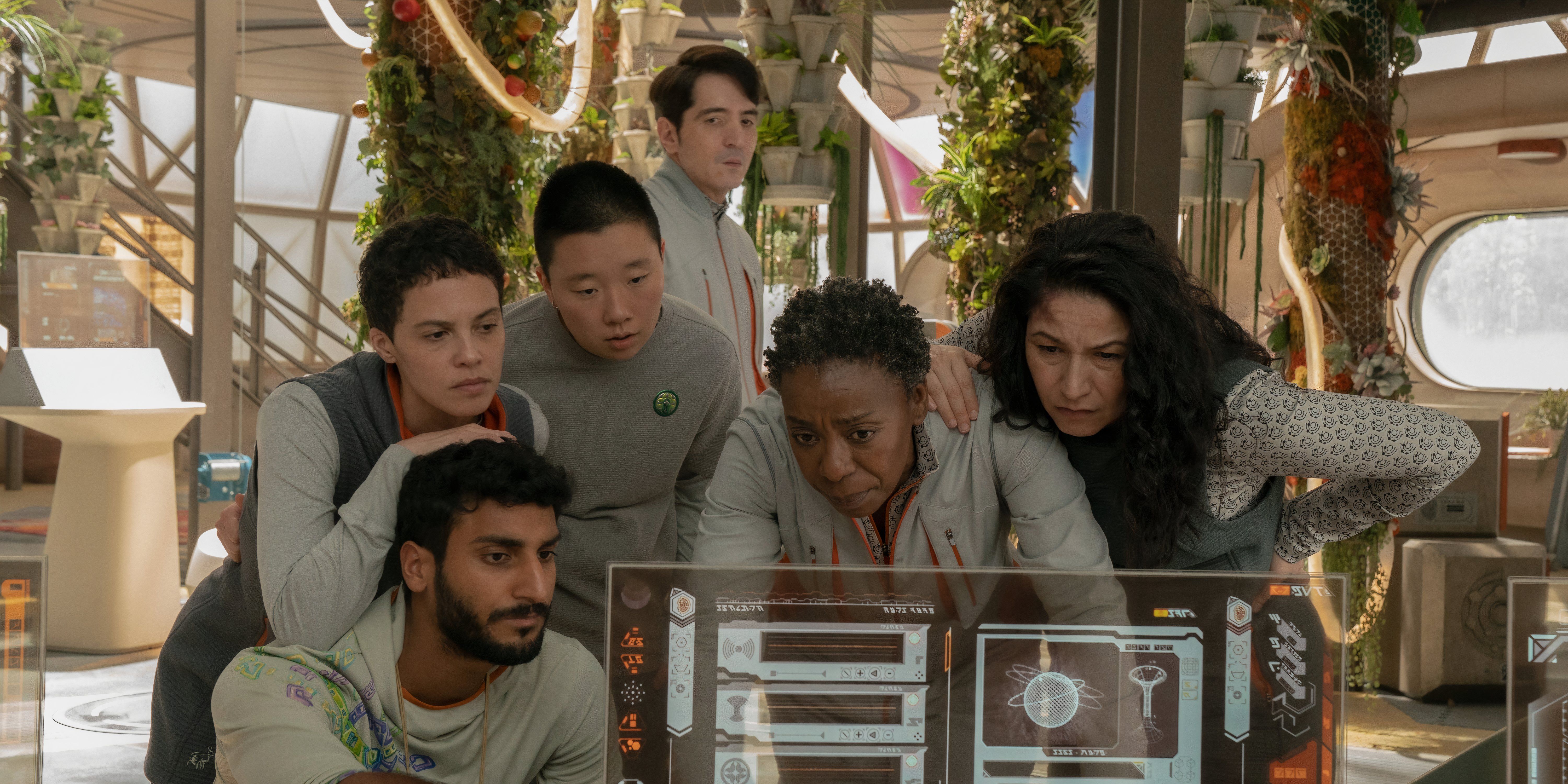 The cast of Murderbot look at something