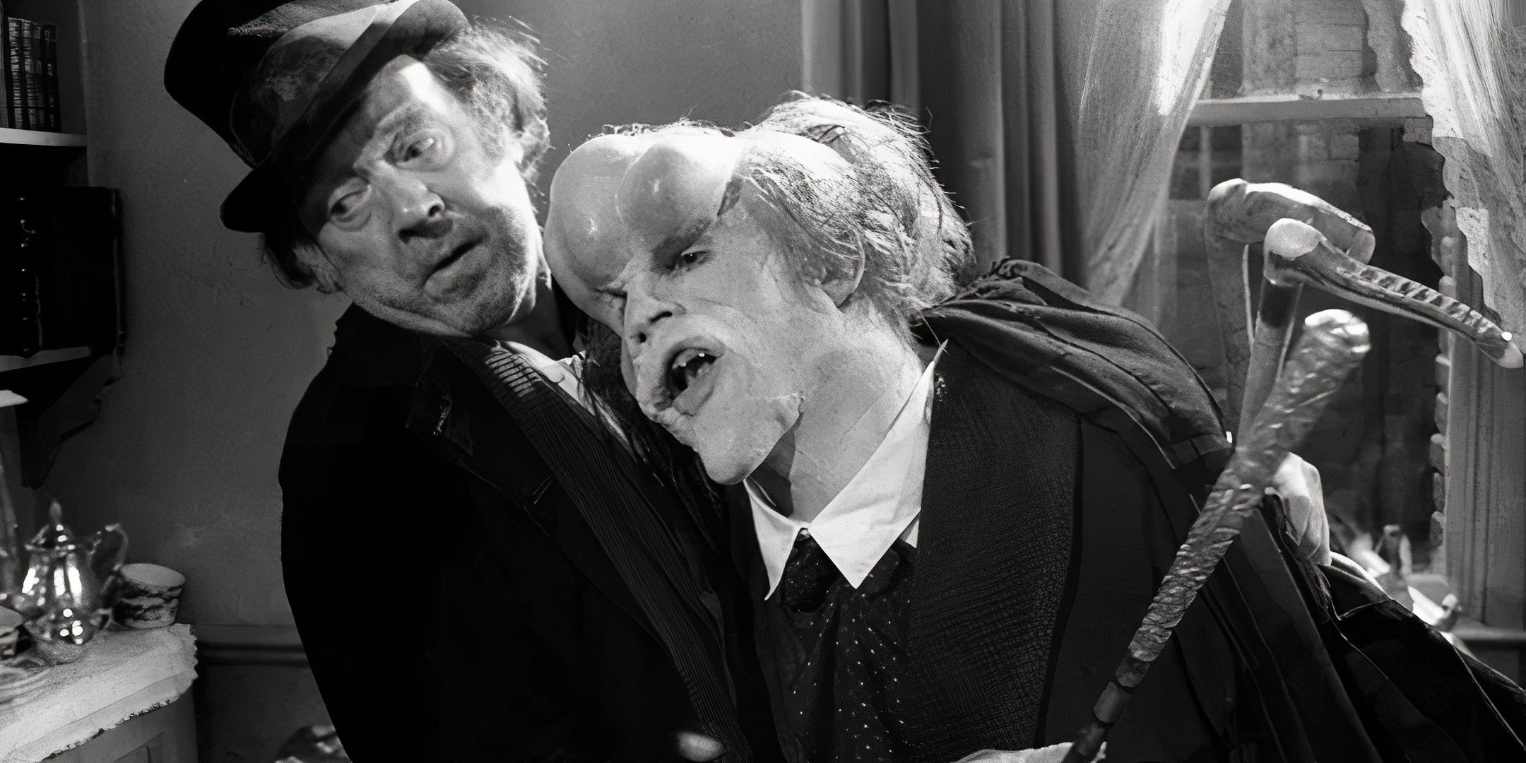 John Hurt as Joseph Merrick leans on Freddie Jones as Bytes in The Elephant Man