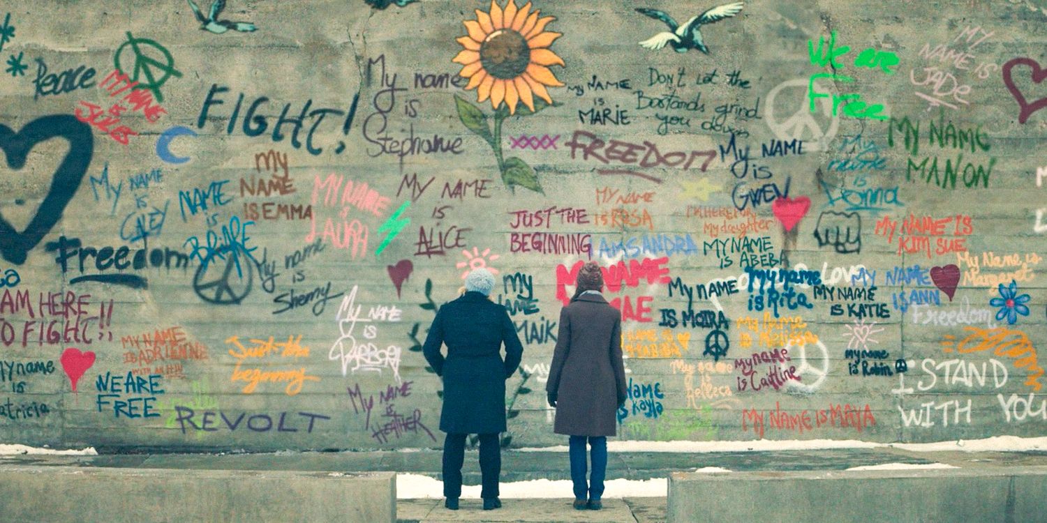 June and Emily looking at the wall with inscriptions of the freed handmaids in The Handmaid's Tale Season 6 Ep 10