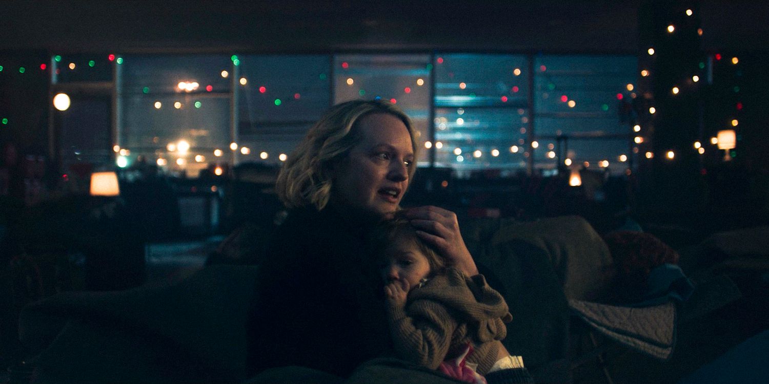 June (Elisabeth Moss) thoughtful, holding her baby close in The Handmaid's Tale Season 6 Ep 10