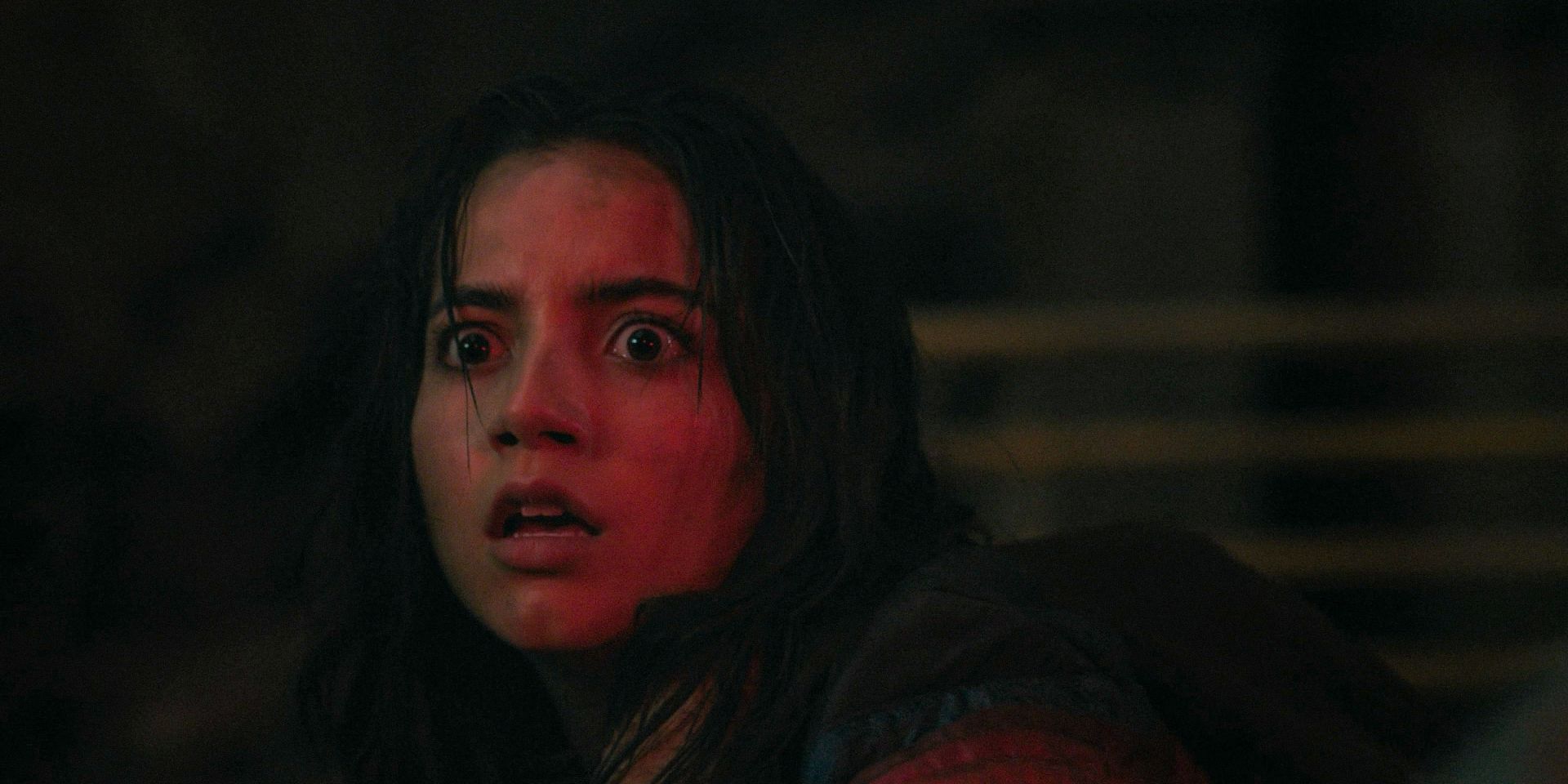Dina (Isabela Merced) scared, illuminated by a red light in The Last of Us Season 2 Ep 4