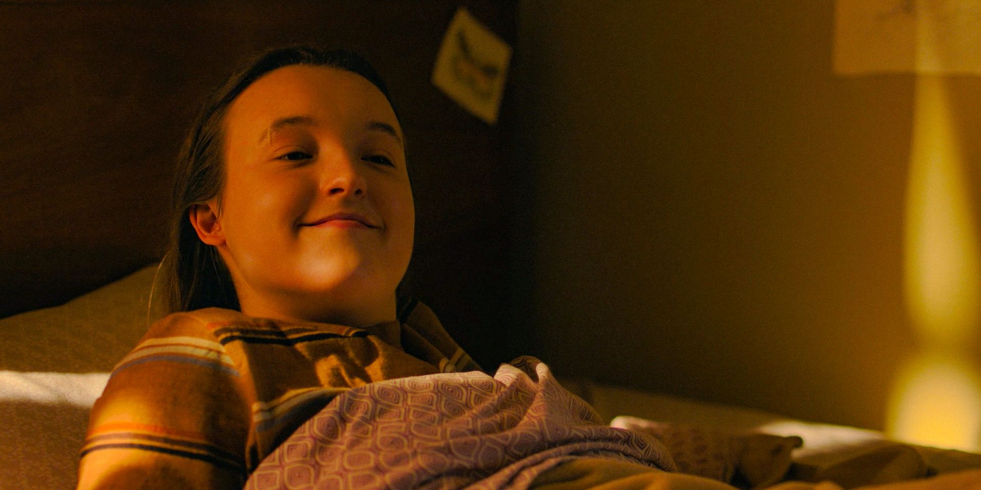 Ellie Williams (Bella Ramsey) with a small, pleasant smile in The Last of Us Season 2 Ep 5
