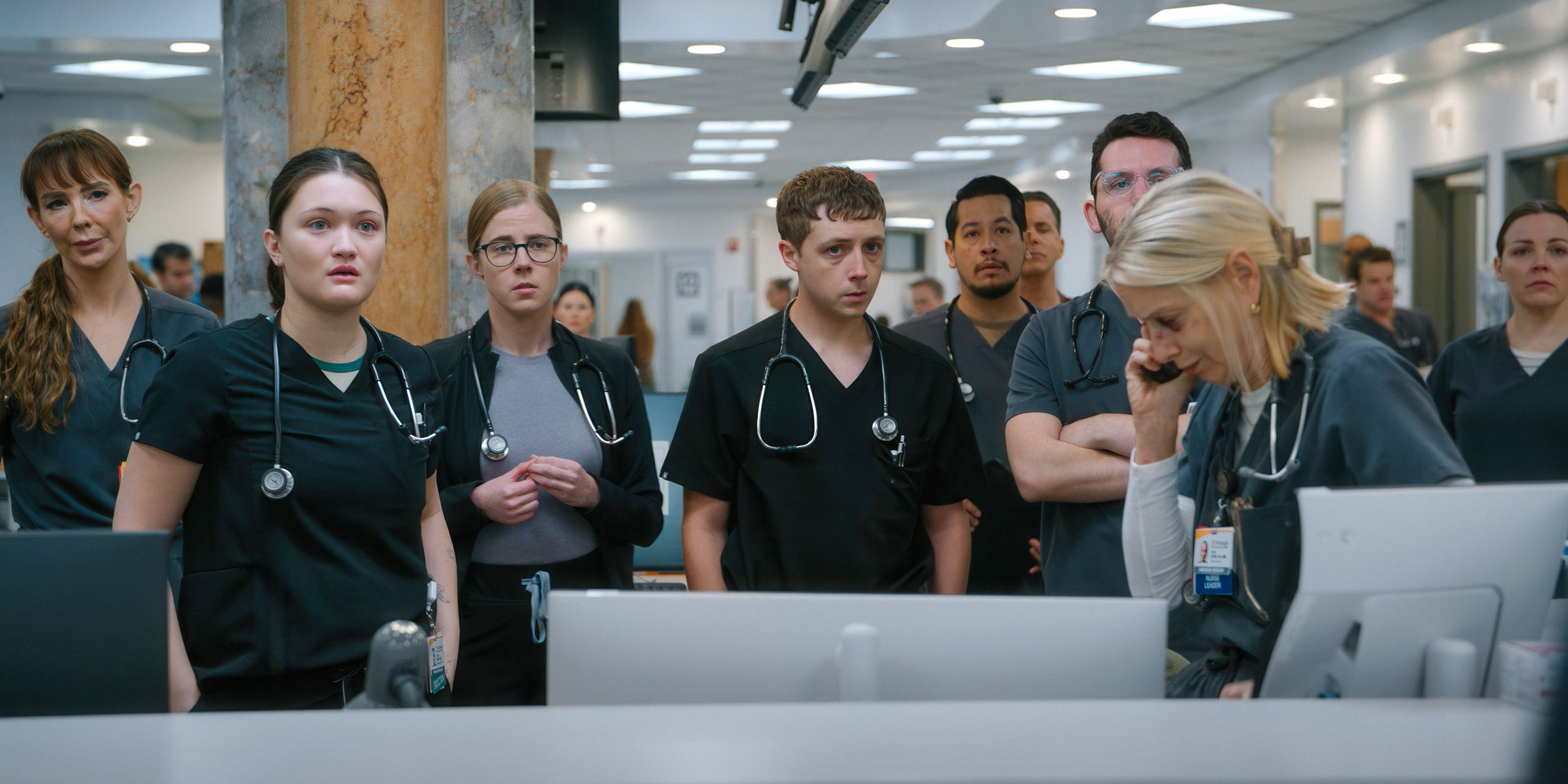 The doctors and nurses of The Pitt season 1 looking defeated around Dana on the phone