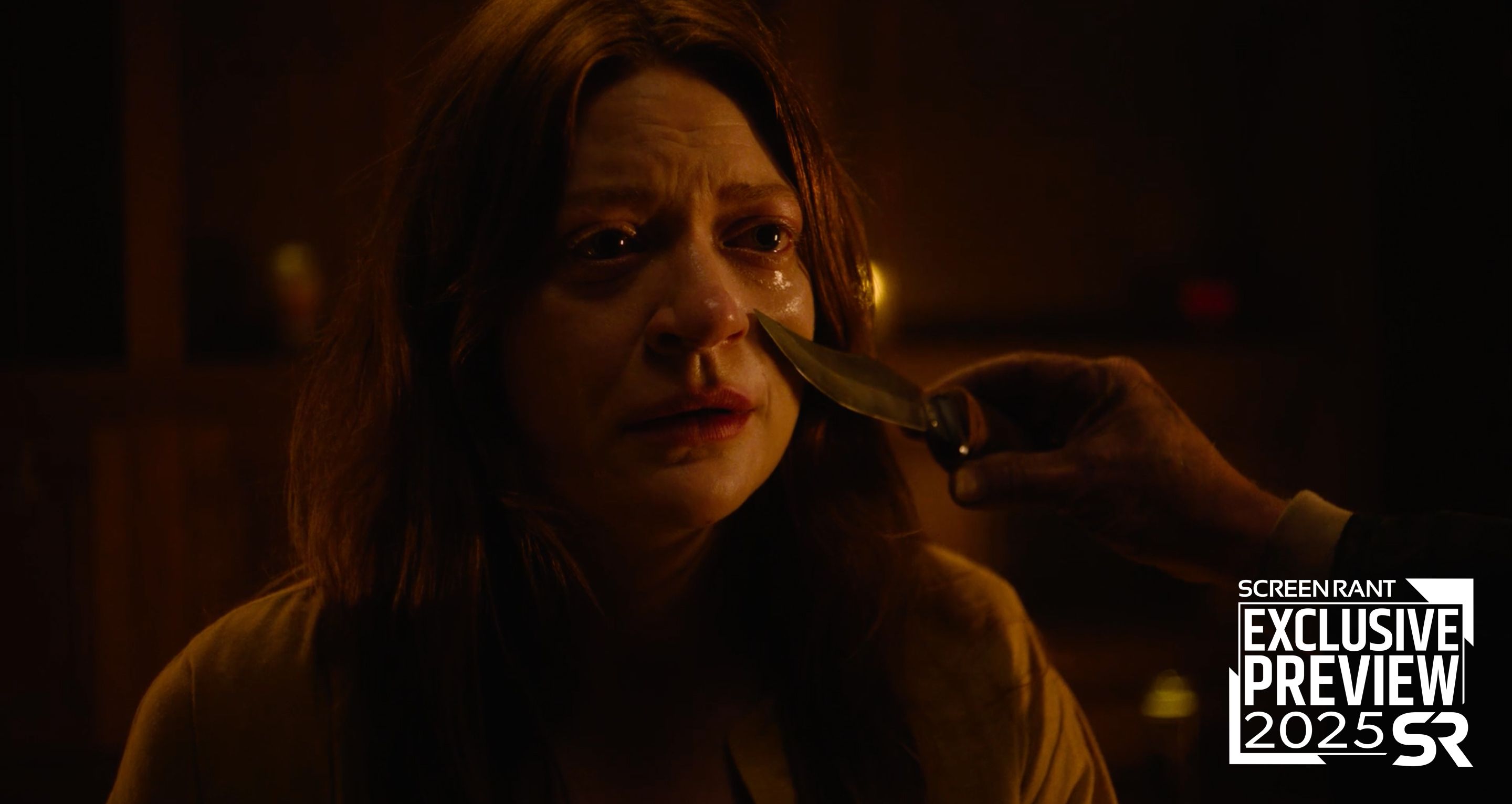 A woman has a knife held up to her face in The Surrender