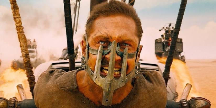 Tom Hardy as Mad Max on the front of a truck in Fury Road