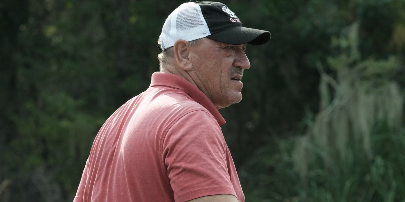 Troy Landry Swamp People on boat looking worried in peach shirt and hat