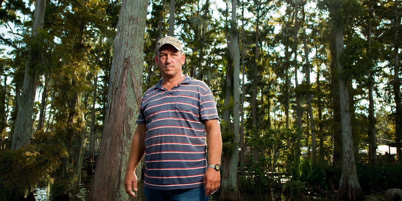 Troy Landry Swamp People standing outdoors in striped shirt