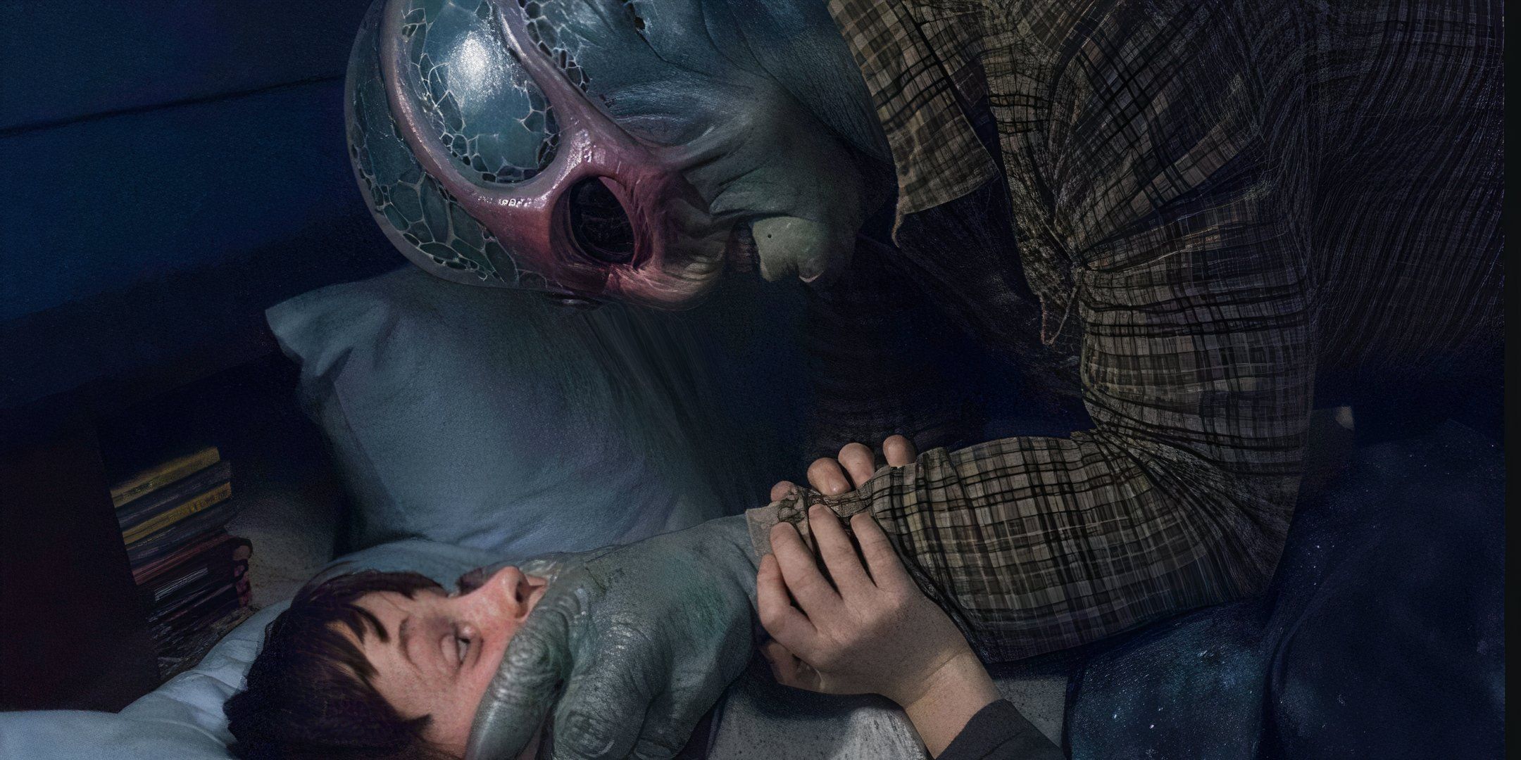 Harry in alien form with his hand over Max's mouth in a bed