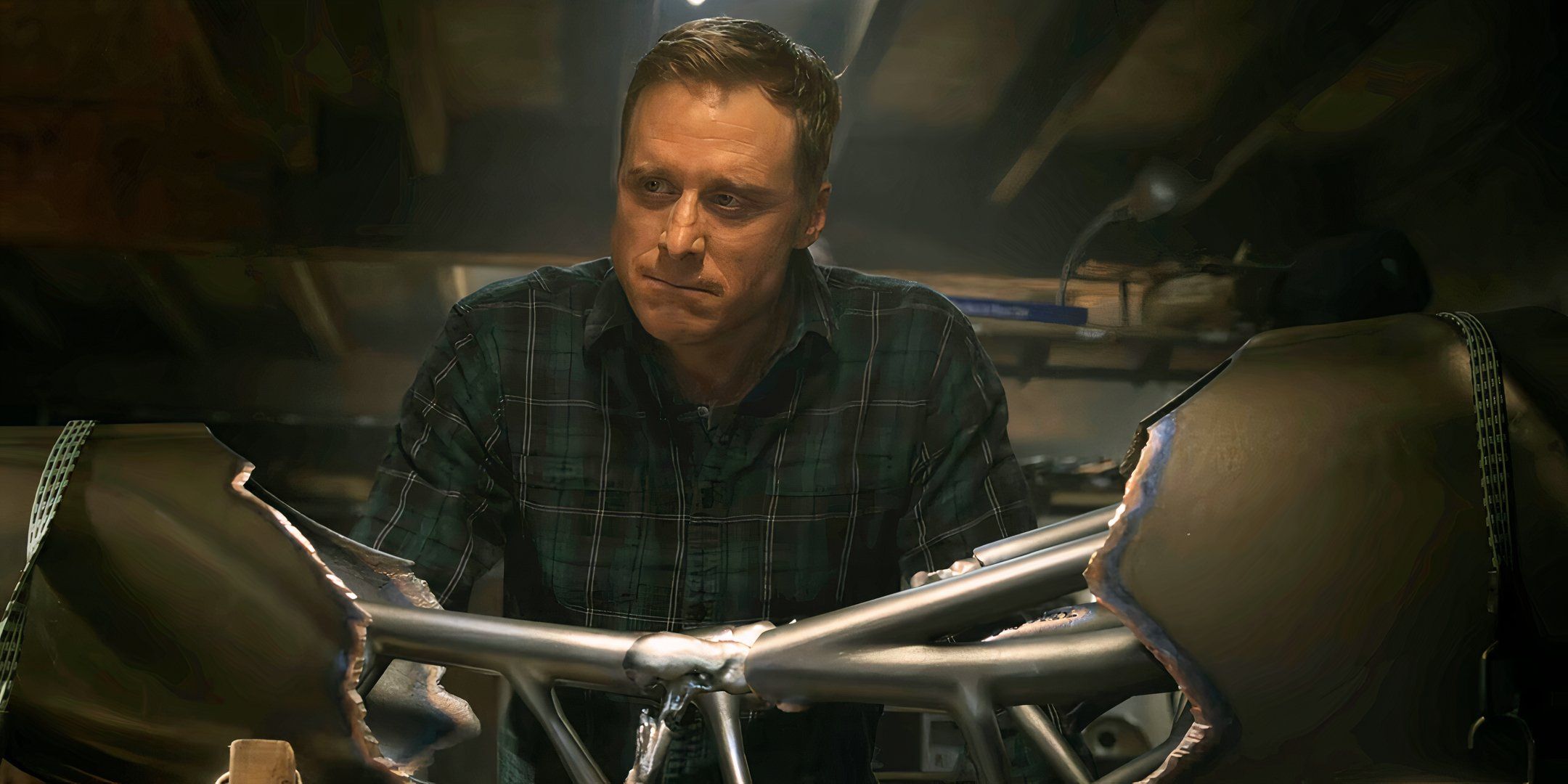 Alan Tudyk as Harry leaning over an alien contraption