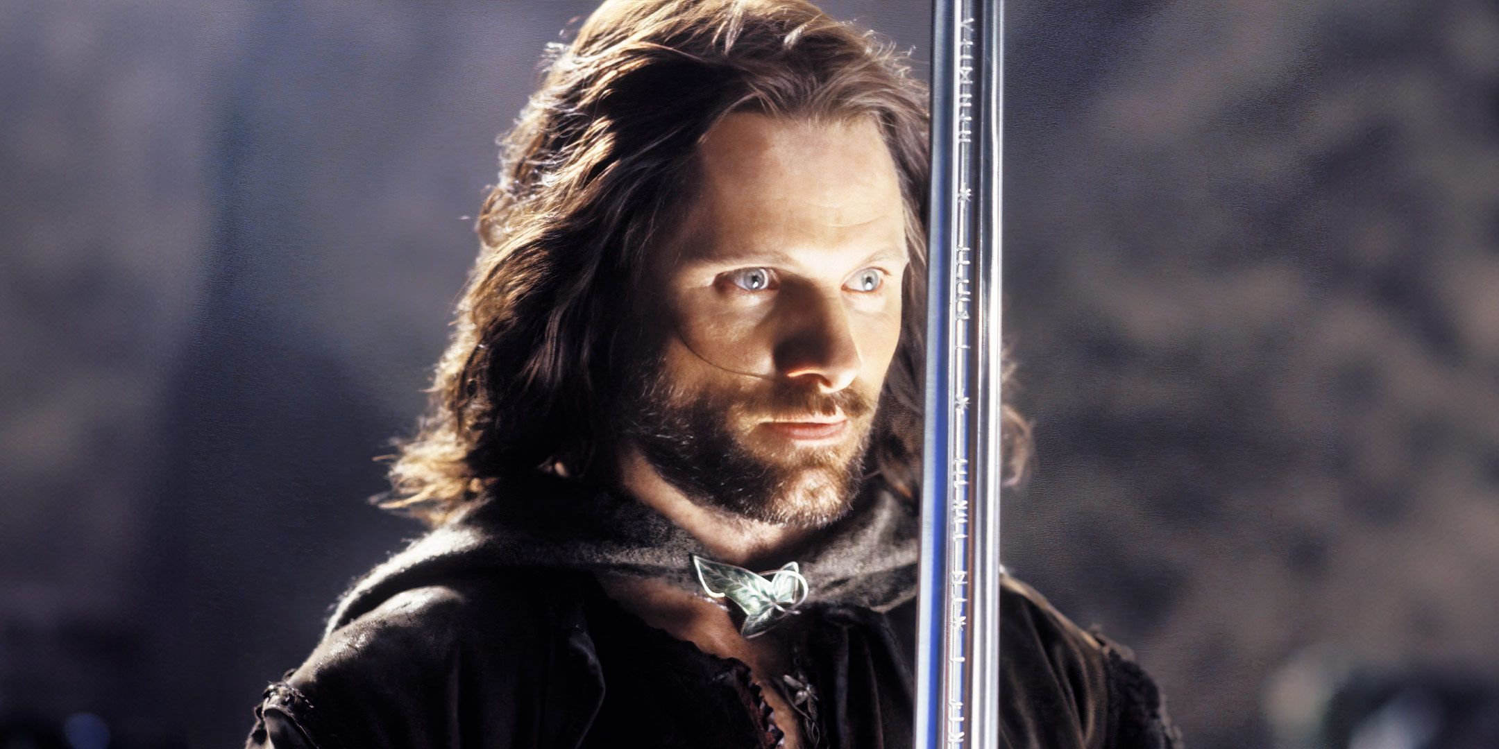 Viggo Mortensen as Aragorn staring at a blade in The Lord of the Rings