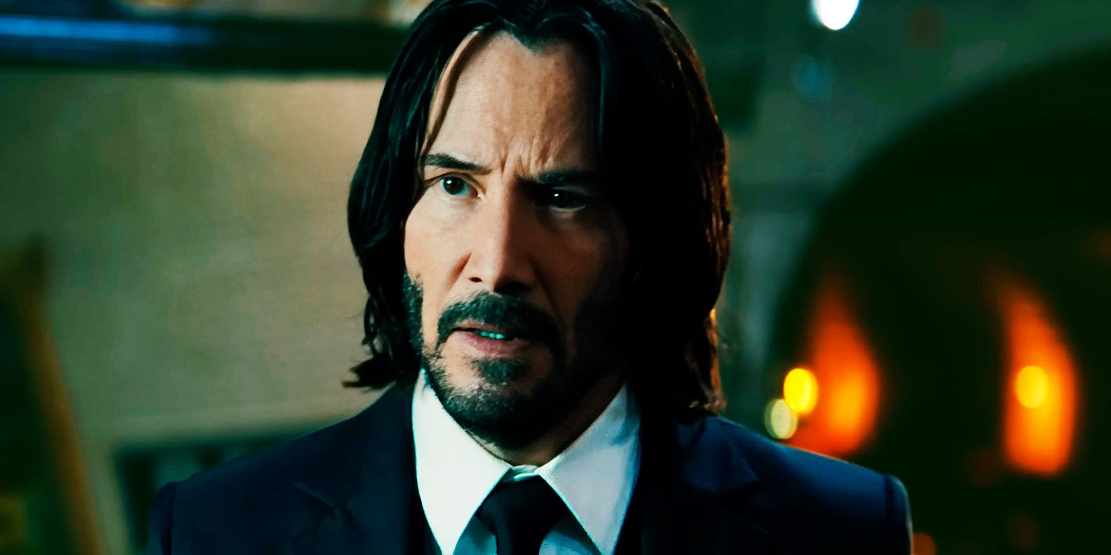 John Wick (Keanu Reeves) standing in a subway station in John Wick