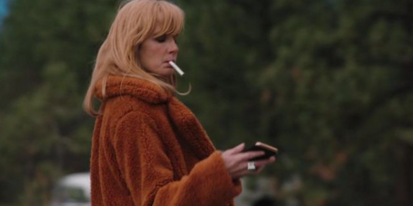 Yellowstone Beth in red coat lighting a cigarette