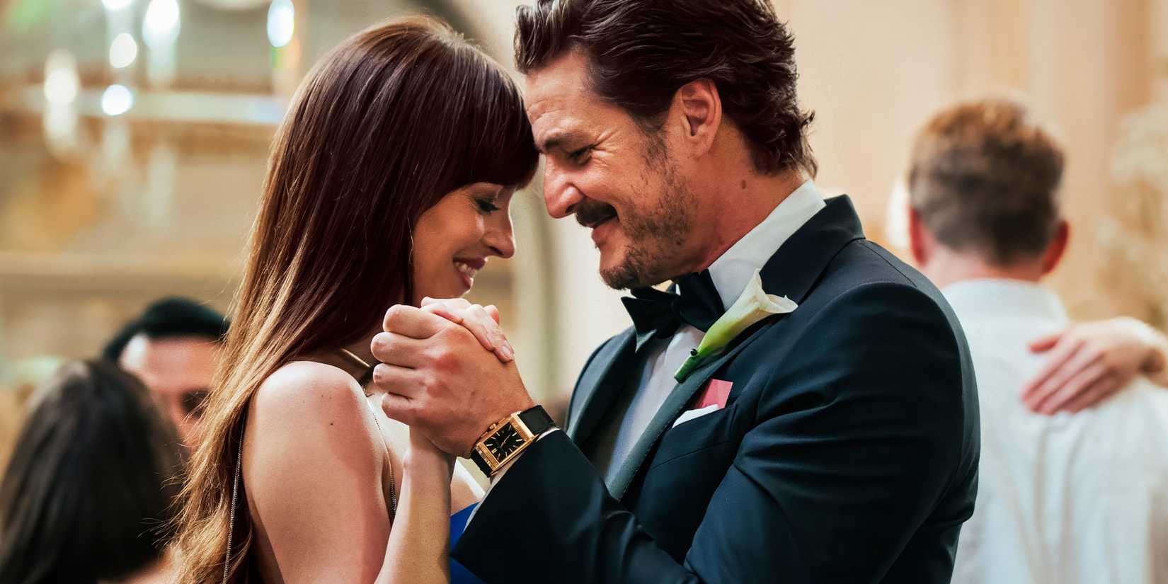 Dakota Johnson and Pedro Pascal slow dancing and smiling in Materialists