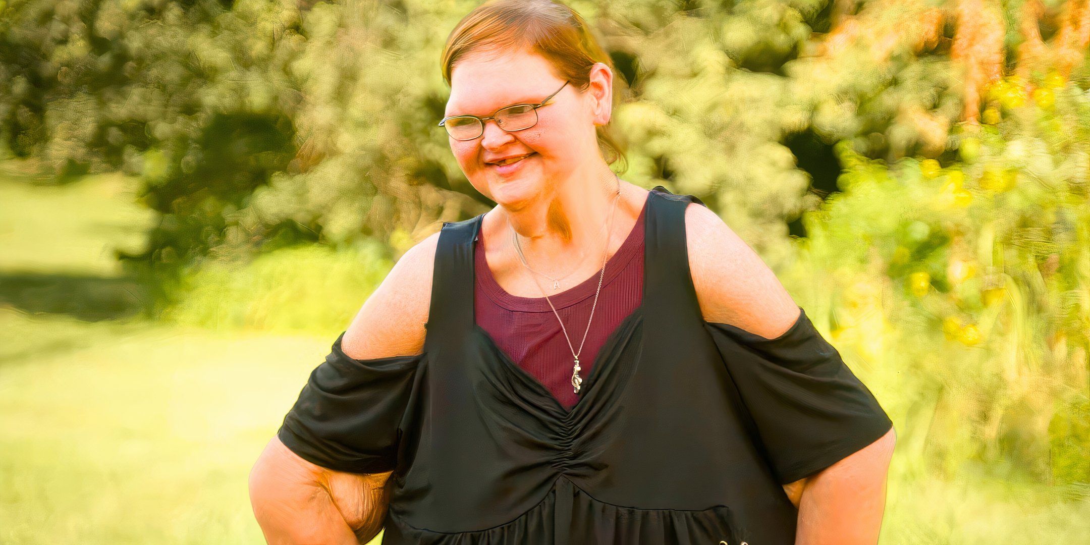1000-lb-sisters-star-tammy-slaton-in-a-black-top-smiling-outside.jpg